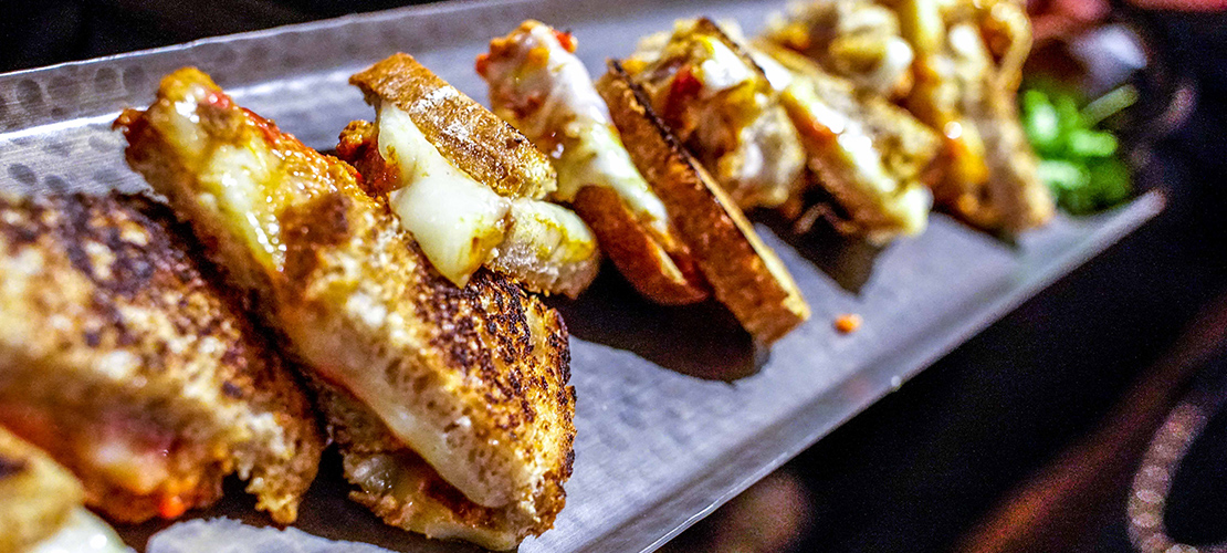 Grilled cheese sandwich halves on a tray