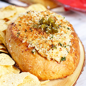 Three Cheese Semolina Loaf with Three Cheese Jalapeno Popper Dip, topped with bread crumbs and bacon bits