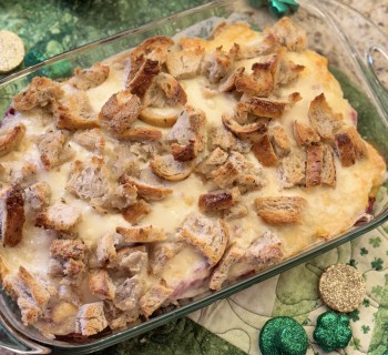 Overhead shot of St Patrick's Day Reuben Casserole featuring New York Rye Loaf artisan bread with festive decorations surrounding the dish