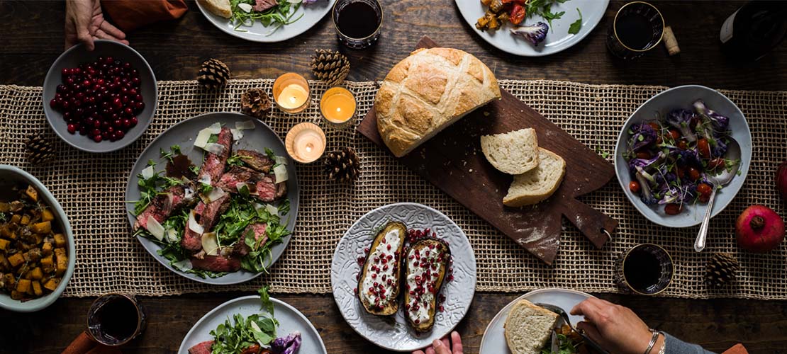 Overhead of table scape with sourdough bread on board