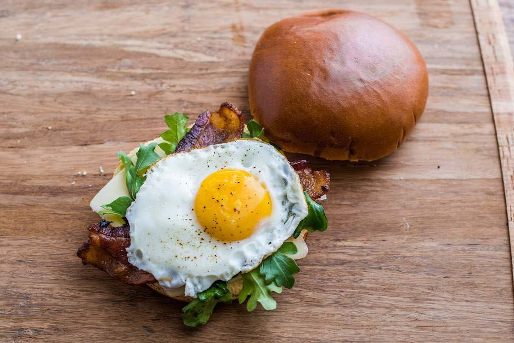 Brioche breakfast sandwich with maple bacon glaze