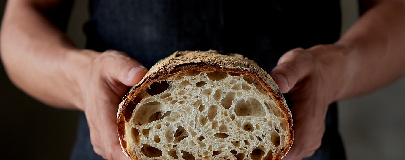 Hands Holding cross section of bread loaf