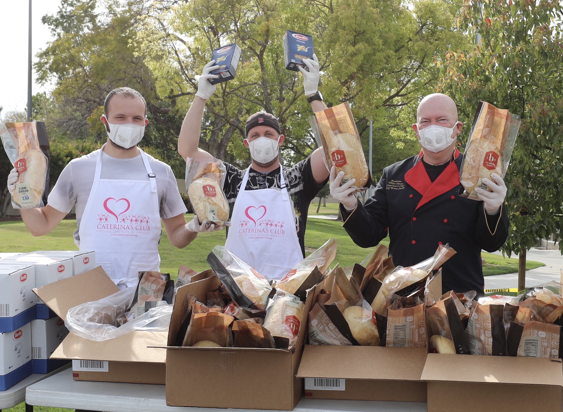 masked men handing out food at Caterinas Club event