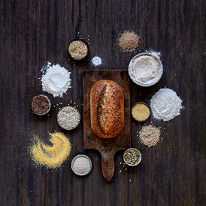 Ingredients scattered around a loaf of bread