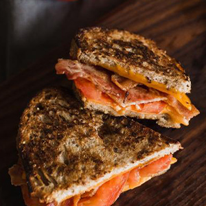 Bacon, cheddar, and tomato grilled cheese sandwich halves