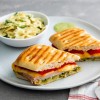 SlicedFocaccia Turkey Pesto Aioli Panini Sandwich on white plate
