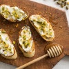 Sourdough Baguette Fresh Ricotta Toast Appetizer with Honey and Pistachios