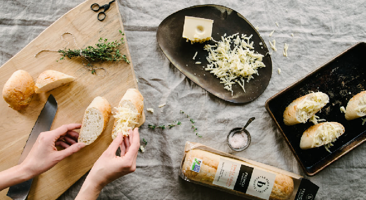 Person cutting slices of bread