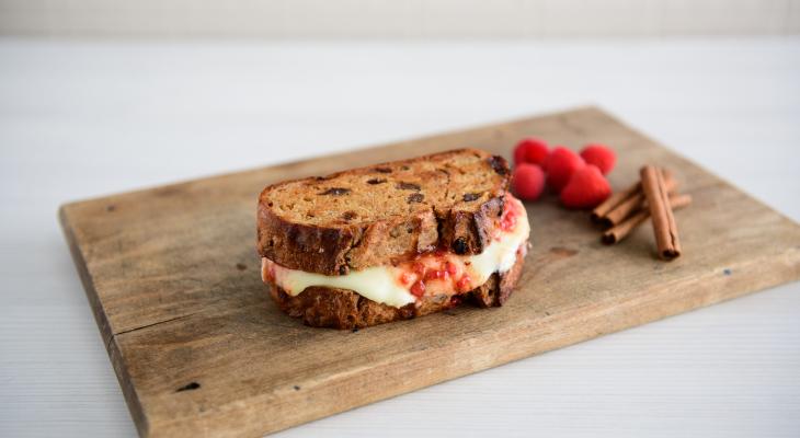 Grilled Cheese Sandwich with Brie made from Cinnamon Raisin Loaf on a cutting board