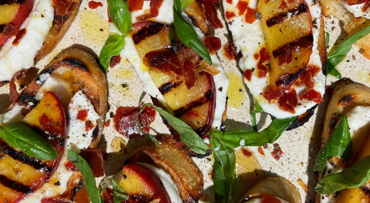 Grilled Crostini with Ricotta, Peaches, Prosciutto, and Hot Honey