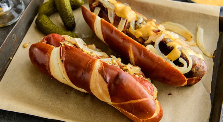 Bratwurst with Caramelized Onions and Stone Ground Mustard on a Pretzel Bun