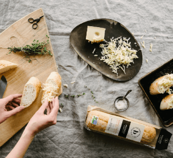 Person cutting slices of bread