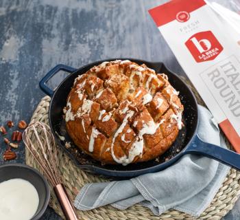 Sweet Skillet Pull-Apart witb Brown Sugar Butter and Glaze in a Skillet with an Italian Round Loaf