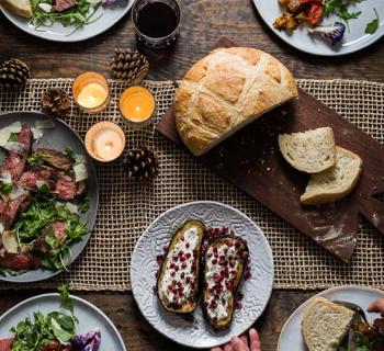 Overhead of table scape with sourdough bread on board