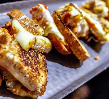 Grilled cheese sandwich halves on a tray