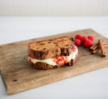 Grilled Cheese Sandwich with Brie made from Cinnamon Raisin Loaf on a cutting board