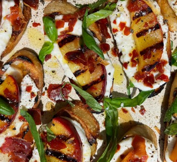 Grilled Crostini with Ricotta, Peaches, Prosciutto, and Hot Honey